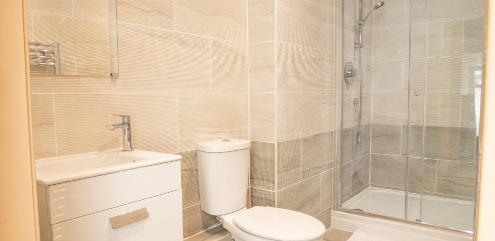 grey-tiled bathroom with textured tiles