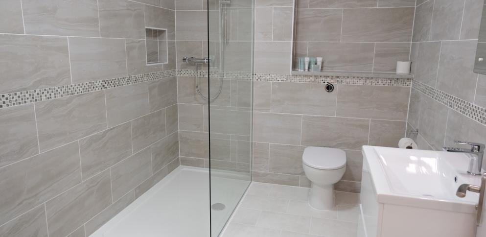 grey tiled bathroom with shower