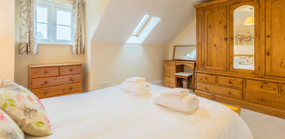 master bedroom in three bedroom apartment at The Ellingham Cottages