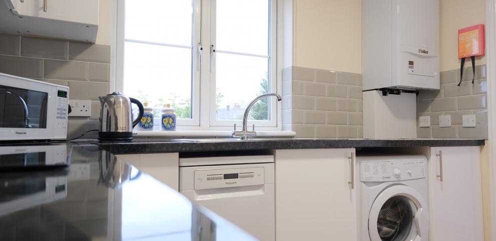 white kitchen with black worktops