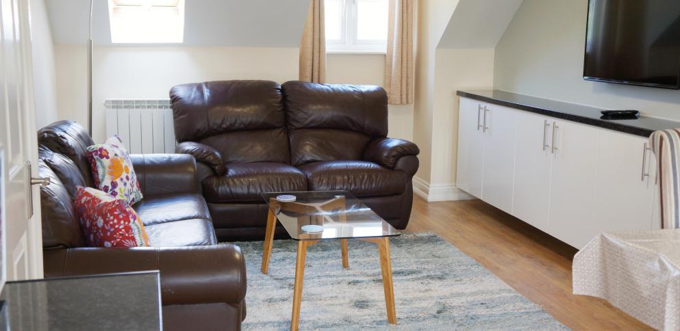 Living room with blue feature wall and breakfast table