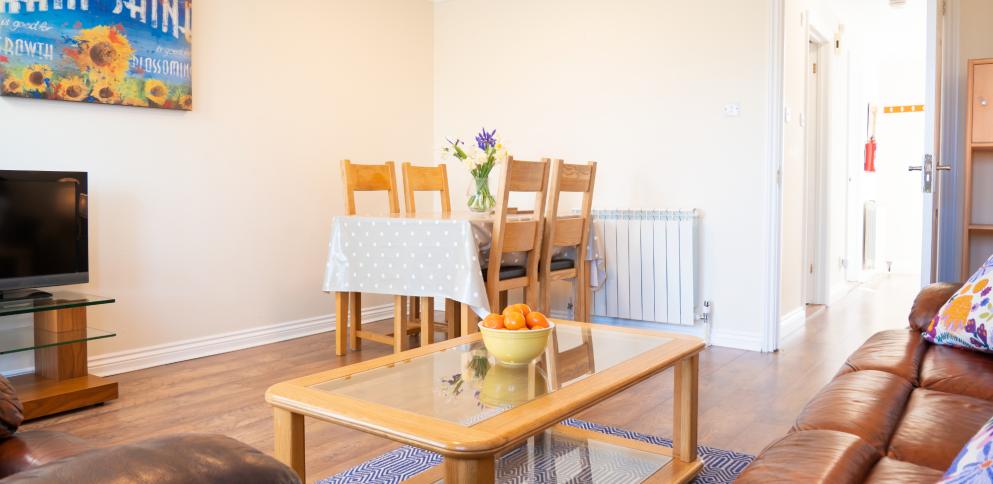 living room with fruit on coffee table