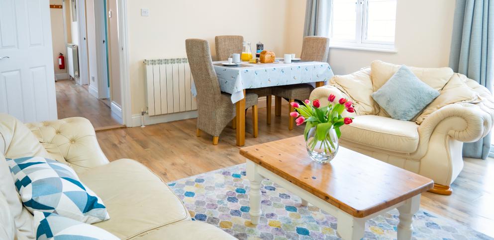 Lights & bright living room with flowers on the table