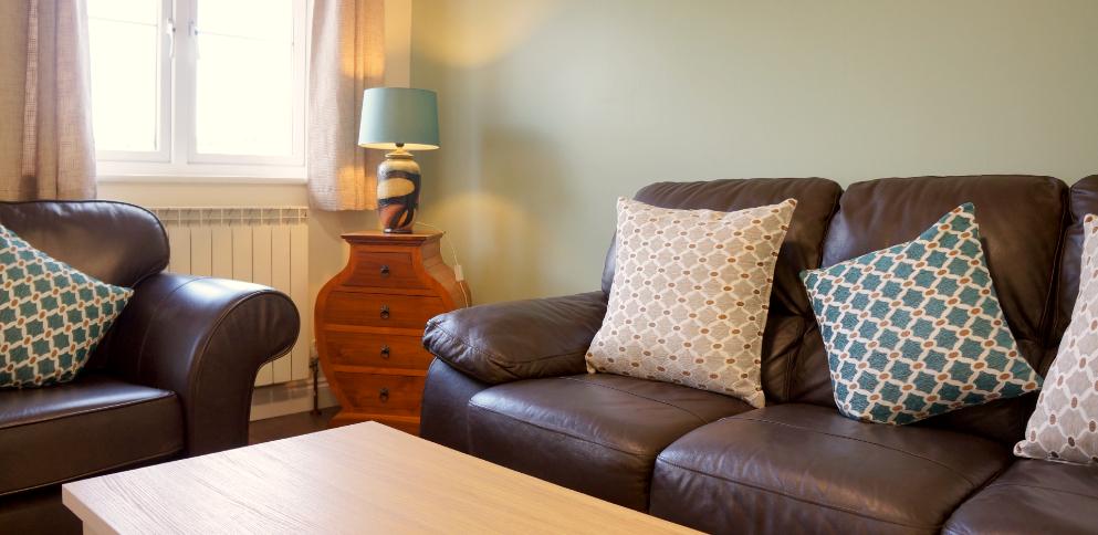 brown leather sofas and table lamp in living room