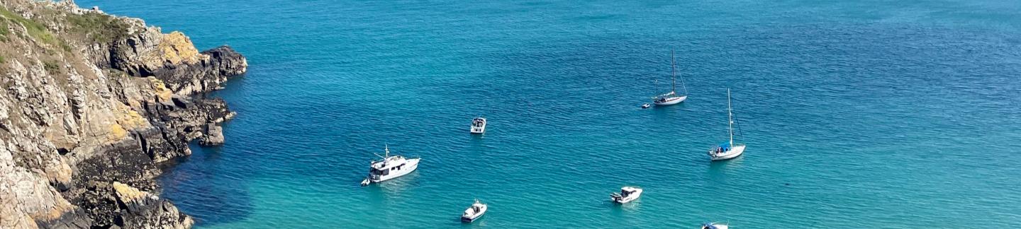 clear blue sea and boats boobing - bids-eye view