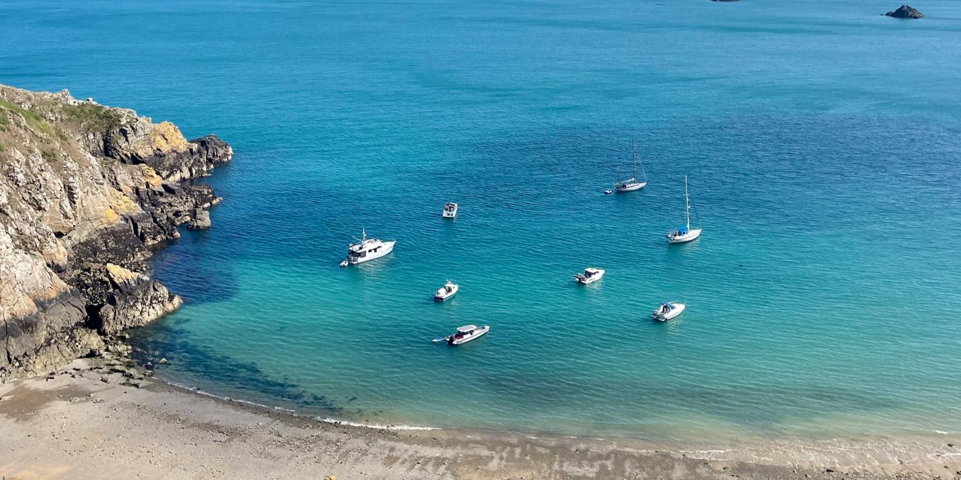 aerial view of boats bobbing in blue sea
