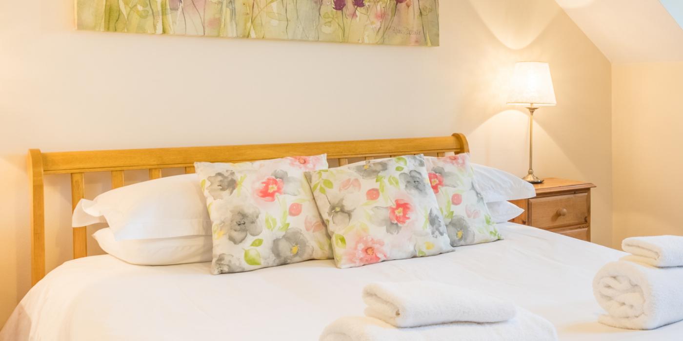 Master bedroom in a cottage at The Ellingham Cottages