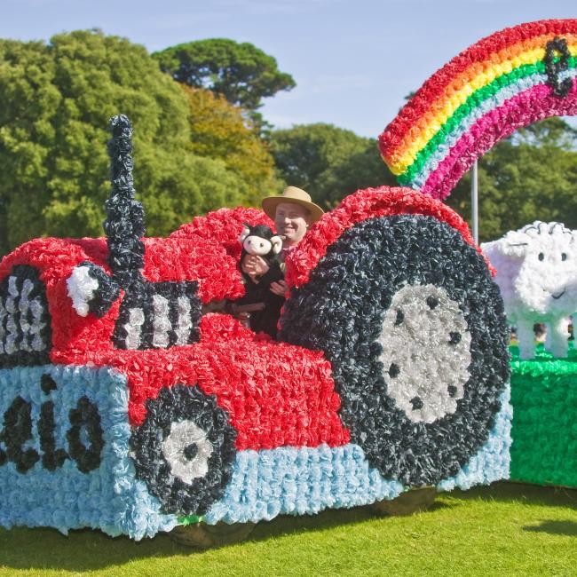 Tractor decorated with flowers in the Guernsey Battle of the Flowers parade.