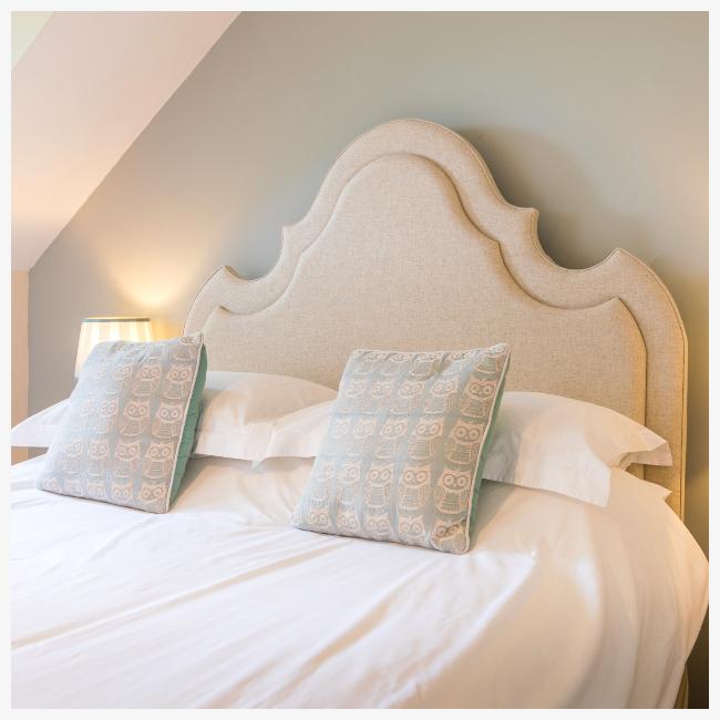 curved headboard in master bedroom at The Ellingham Cottages, St Martins, Guernsey