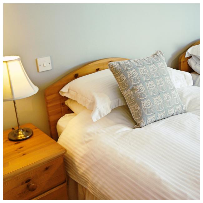 Bed in twin bedroom at The Ellingham Cottages, St Martins, Guernsey