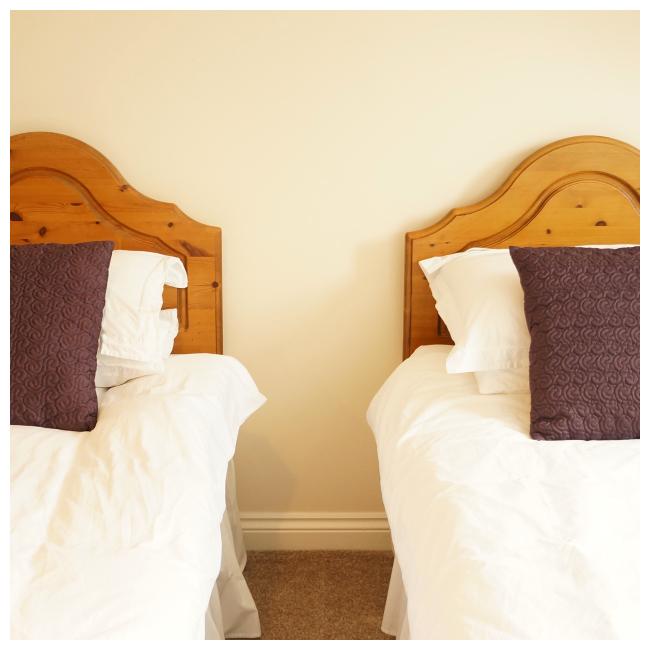 side shot of two single beds in The Ellingham Cottages, St Martins, Guernsey