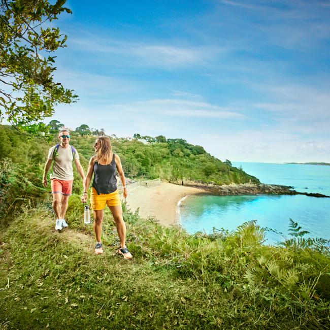 couple walking on the south coast in Guernsey