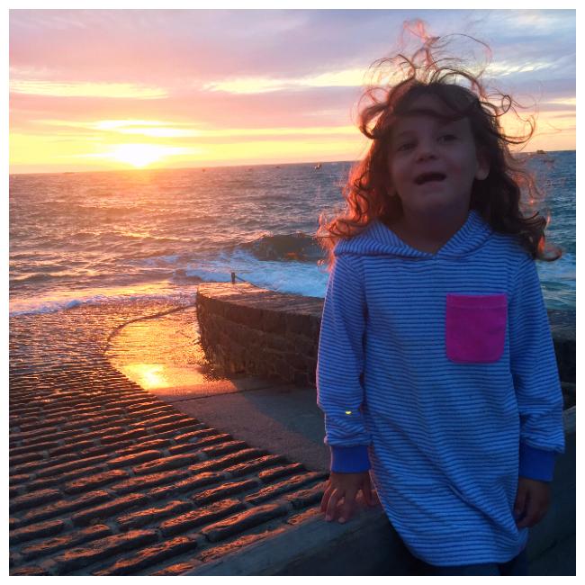 Girl in front of sunset in Guernsey