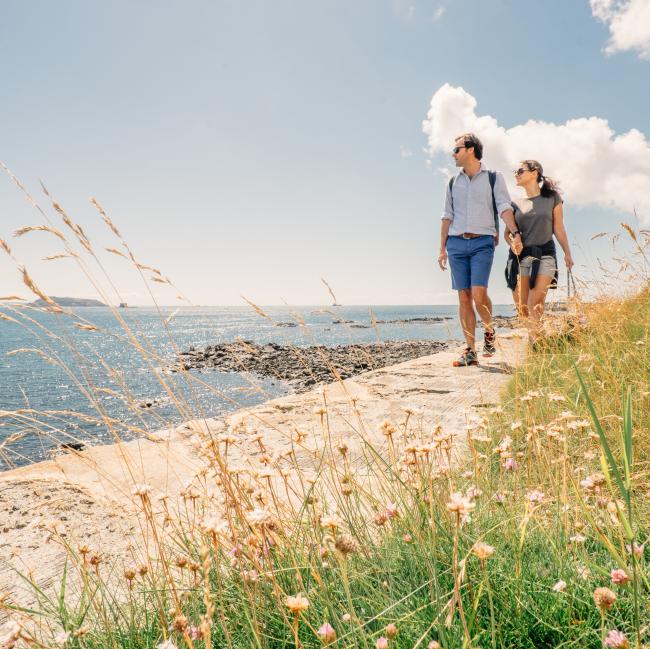 couple walking by the beach in the north of Guernsey